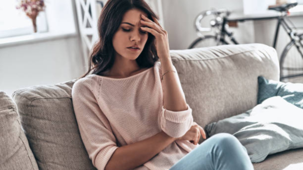 Woman experiencing fatigue, a possible sign of an impending heart attack.
