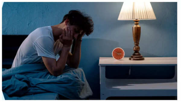 Sleepless woman, highlighting sleep disturbances as a potential heart attack symptom.