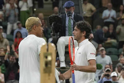 Taylor Fritz greets Gabriel Diallo after Wimbledon match.